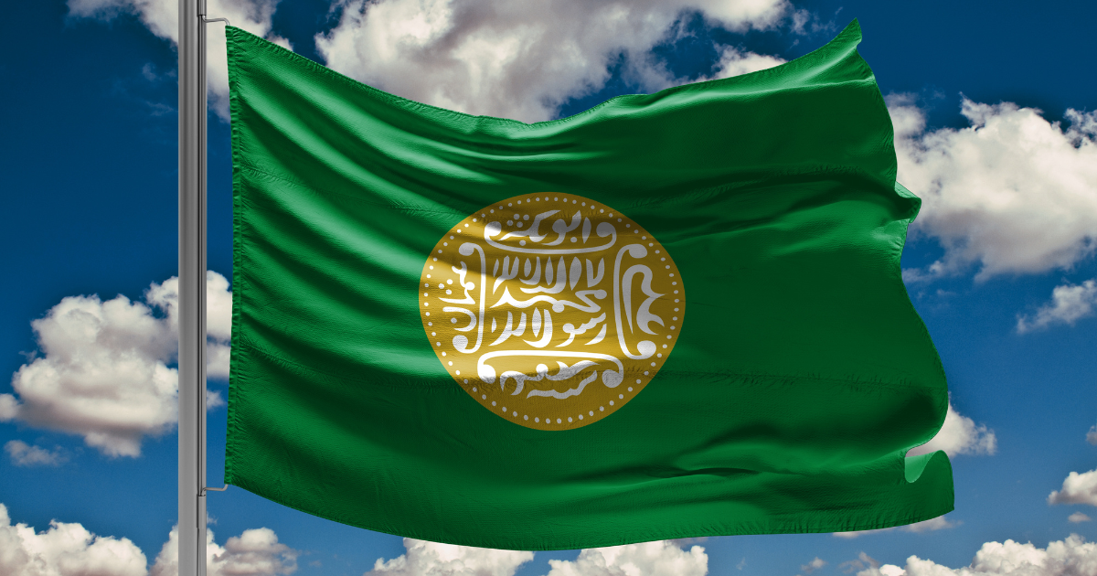 una bandiera verde con un sigillo d'oro sopra.